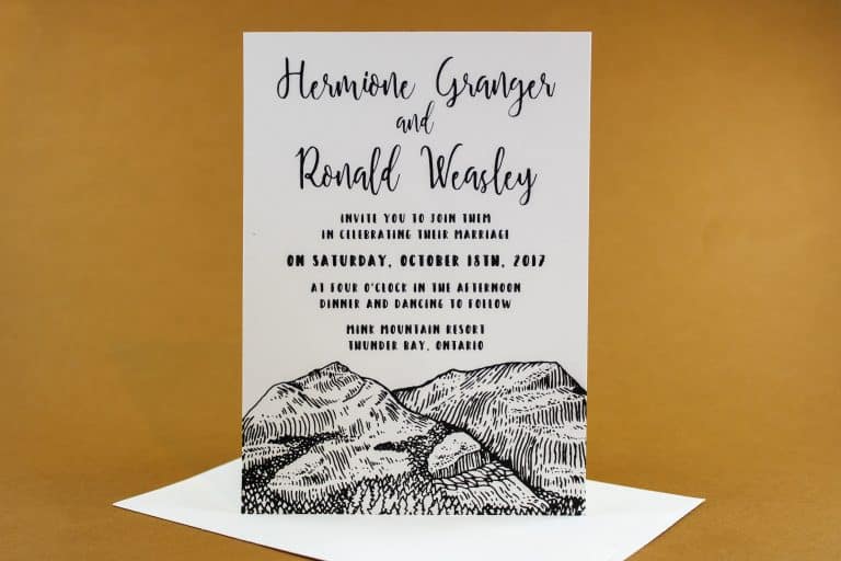 Wedding invitation suite paired with envelope in minimalist outdoor design.